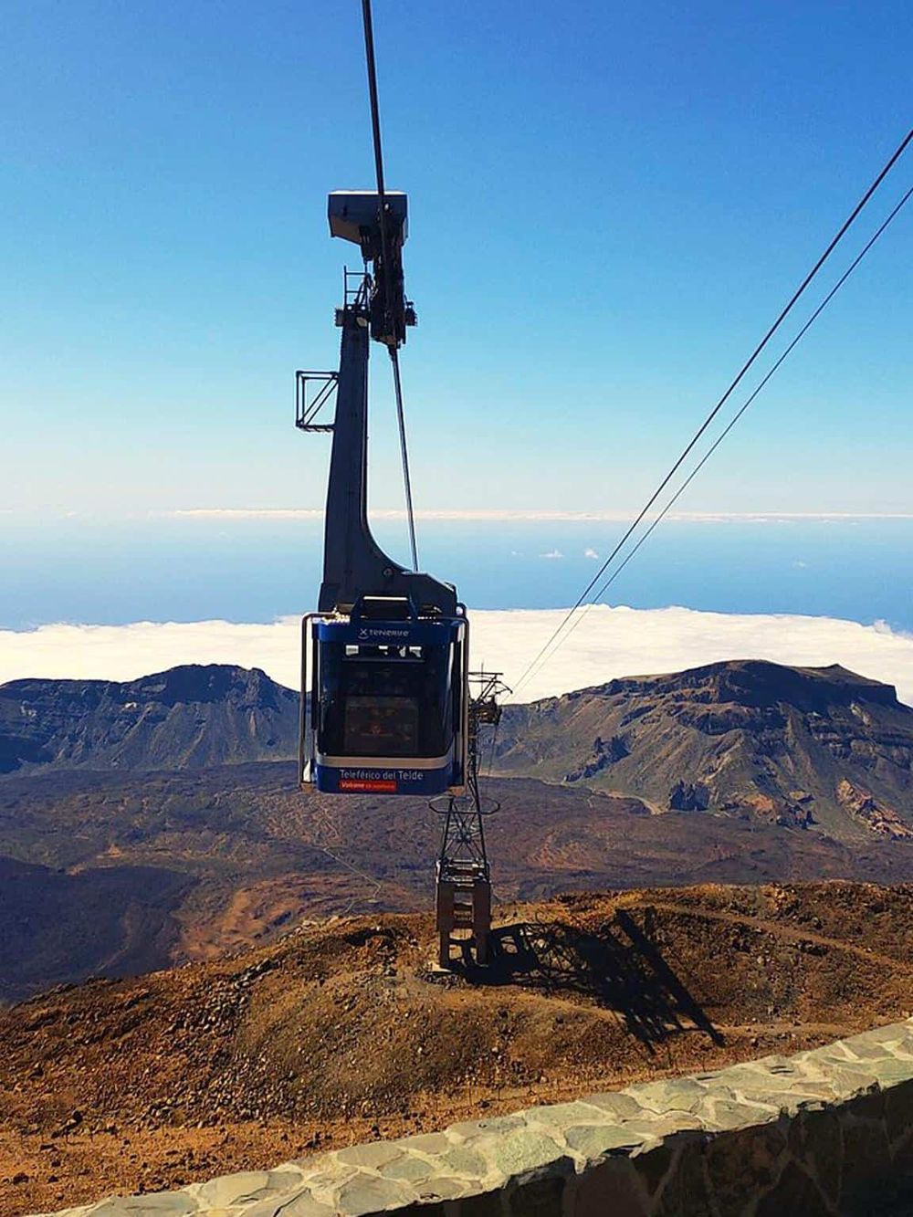 Cable car ascent to volcanic mountain crater with panoramic views at Teide National Park.