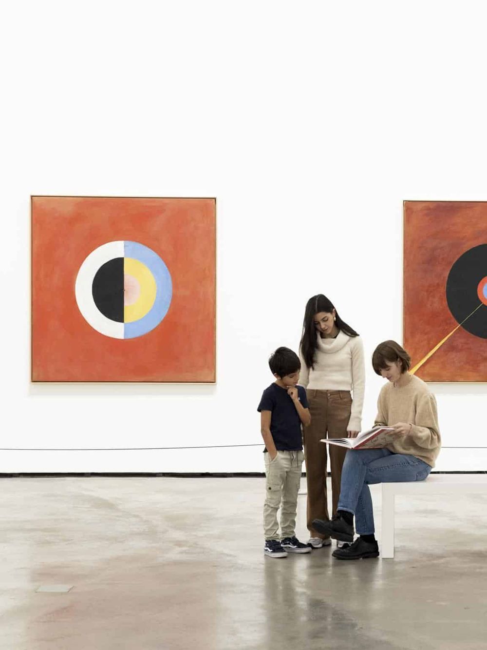 Colorful abstract art at a gallery with visitors exploring artwork and engaging with exhibits.