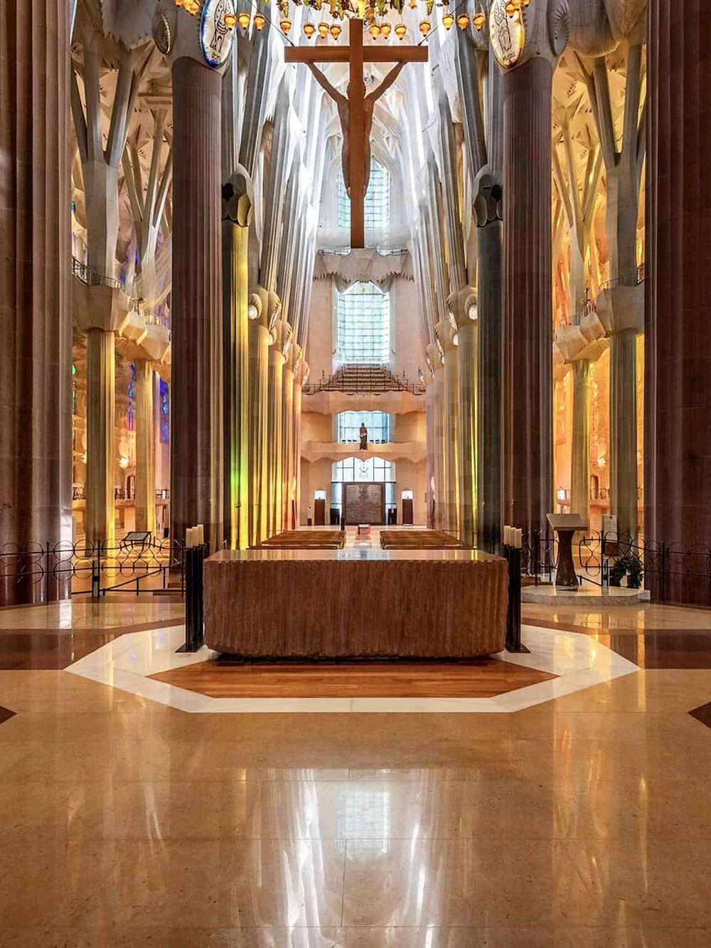 Serene interior of the Sagrada Familia church in Barcelona, showcasing stunning architecture and vibrant lighting.