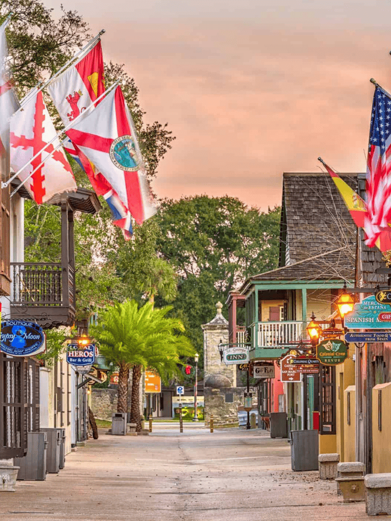 Colorful historic downtown street with flags, shops, and vibrant atmosphere, ideal for exploring local culture and navigation.