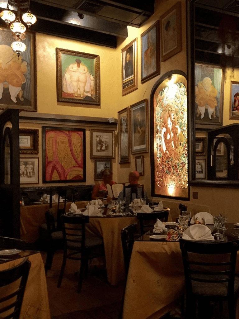 Vibrant dining area with eclectic artwork in an upscale restaurant interior.