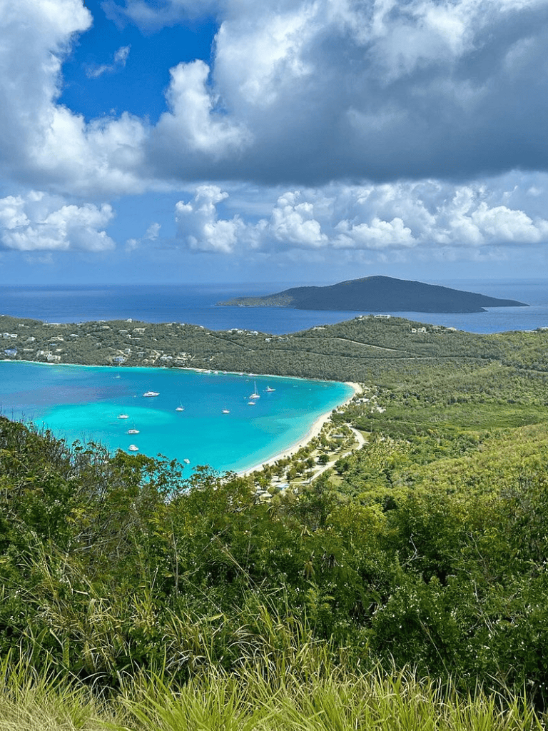 Stunning tropical bay with turquoise waters and lush greenery, perfect for water activities and scenic exploration.