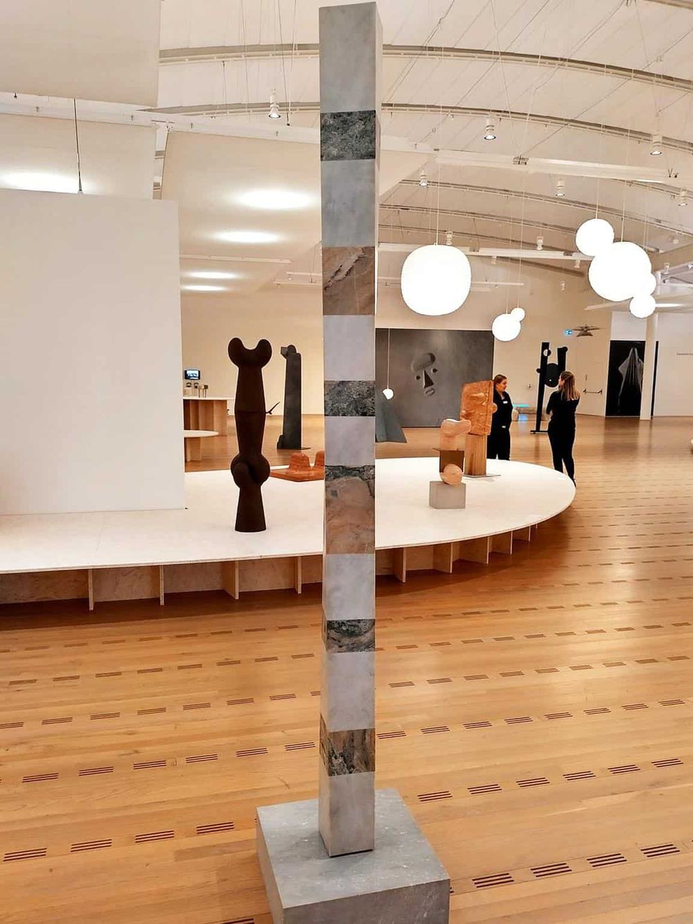 Colorful marble sculpture in a modern art gallery interior.