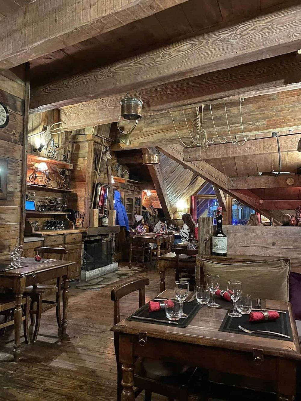 Cozy rustic restaurant interior with wooden beams and tables, Celtic decor, perfect for mountain lodge dining experience.