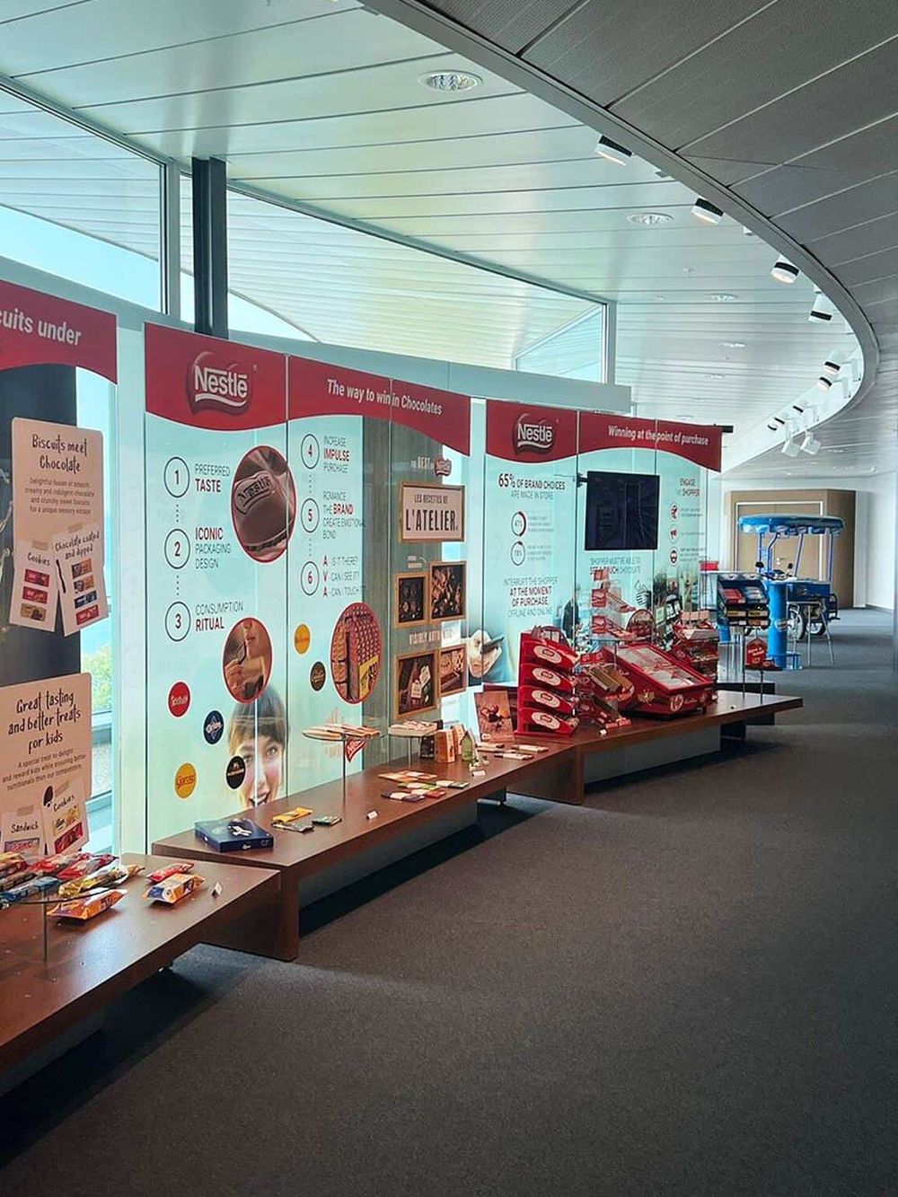Nestlé chocolate promotion display at an airport or public venue, showcasing branding and product info.