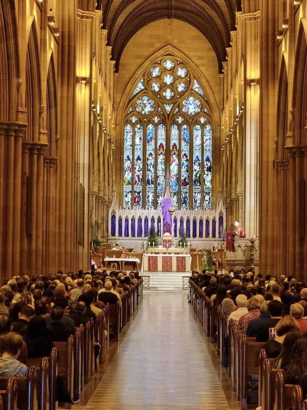 Impressive church interior showcasing stunning stained glass and Gothic architecture for spiritual exploration.