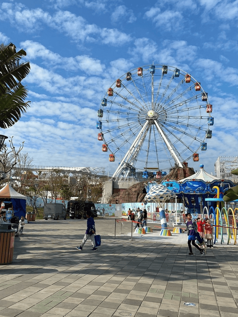 Colorful amusement park Ferris wheel at Quest For Directions, offering fun family attractions and scenic views.