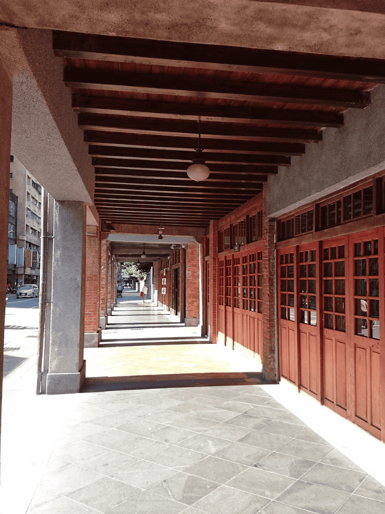 Covered sidewalk with wooden details and brick accents, perfect for urban explorers and pedestrian-friendly shopping districts.