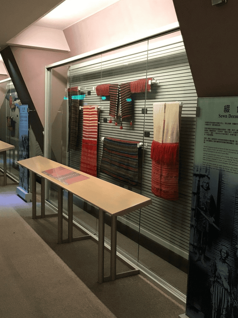 Woven textiles display at QuestForDirections museum showcasing traditional craftsmanship.