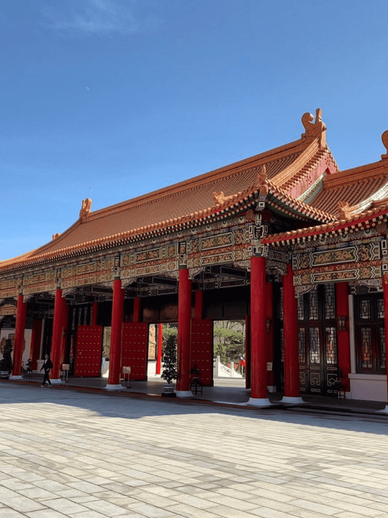 Traditional Chinese temple with ornate architecture and red columns, beautiful cultural site for travel and exploration.