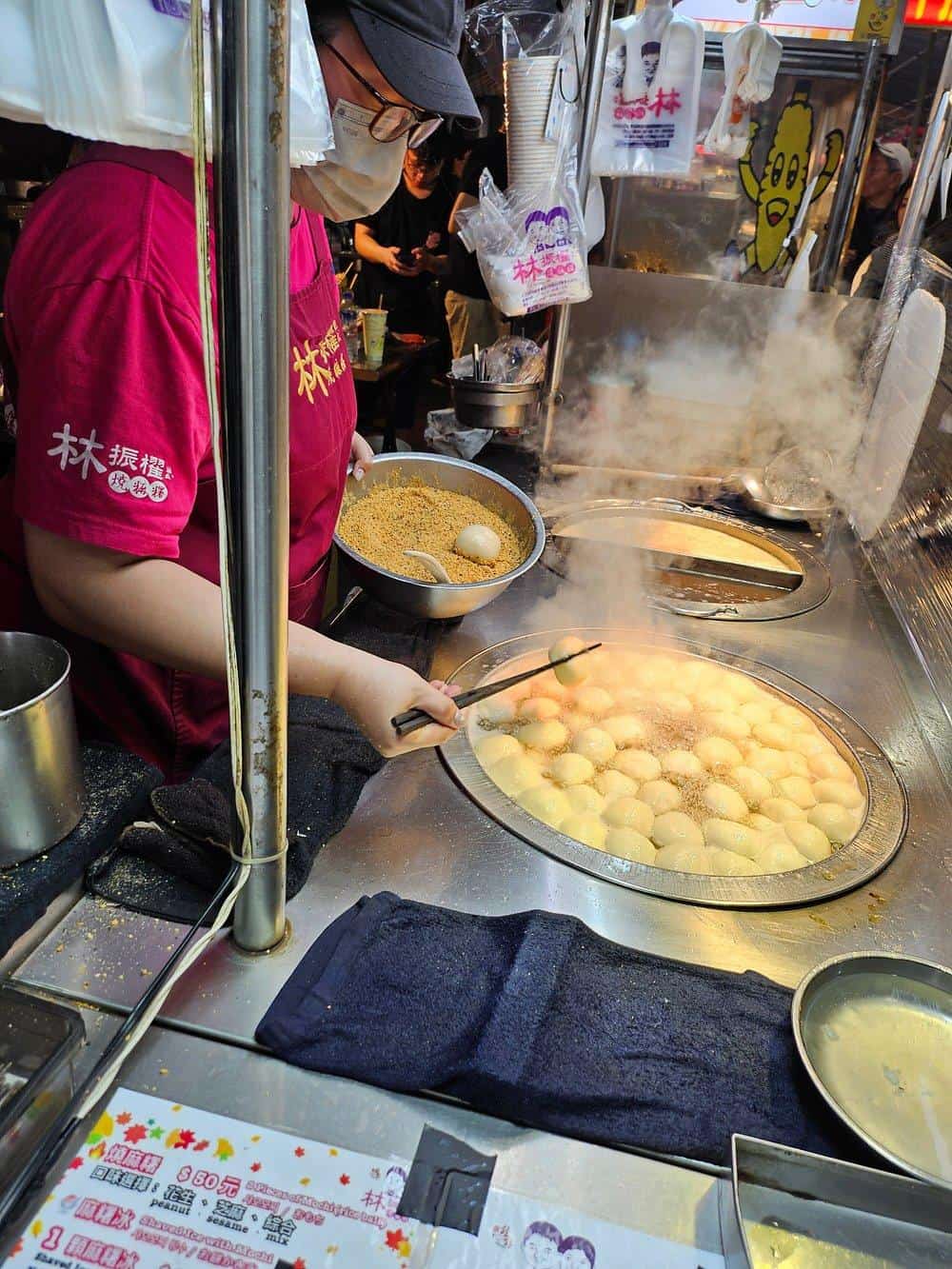 Steamed fish balls being prepared at a street food stall in Taiwan for authentic Asian cuisine.