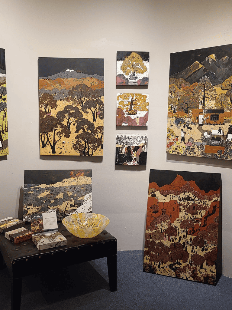 Vibrant landscape paintings showcasing nature scenes at QuestForDirections art exhibit.