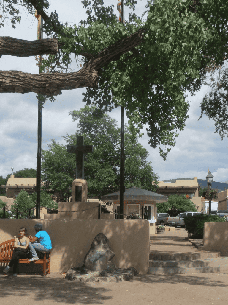 Aerial view of scenic Quest for Directions park with native art, trees, and visitors enjoying the outdoor space.