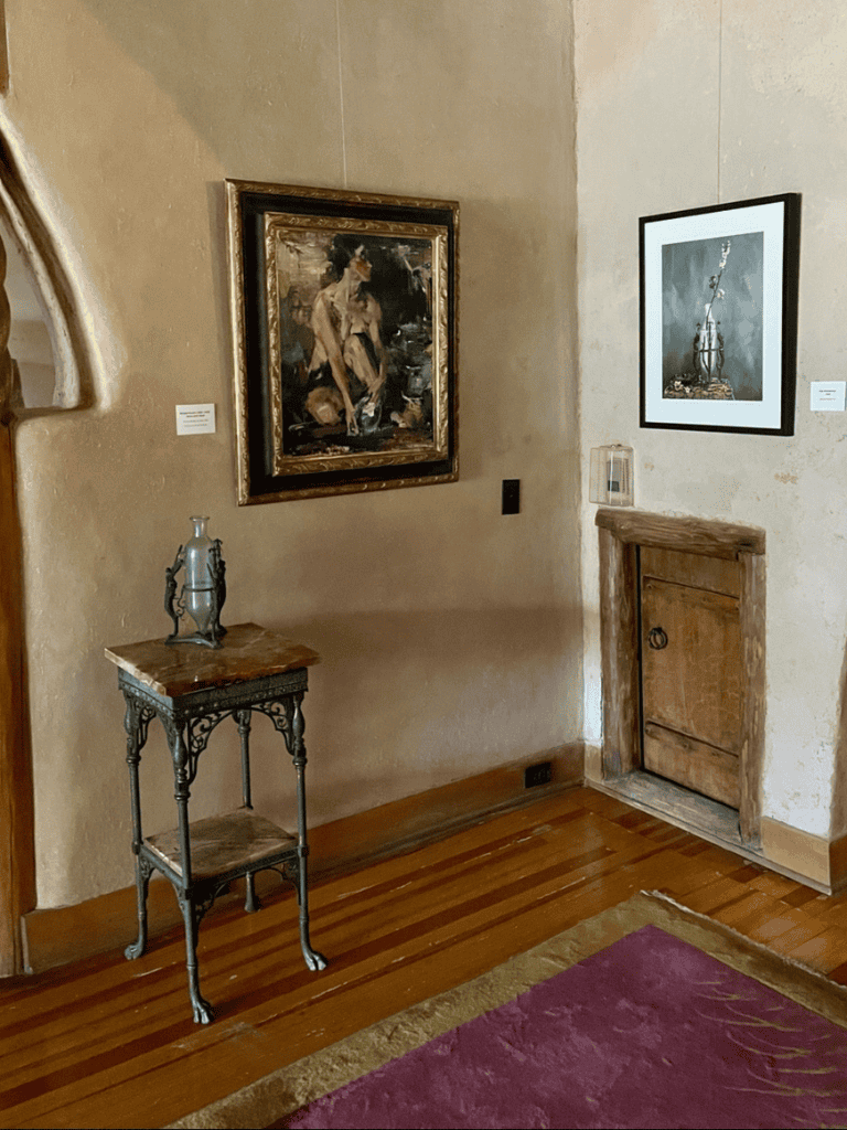 Elegant art gallery interior showcasing modern paintings, rustic wooden floors, and vintage accents for a cultural experience.
