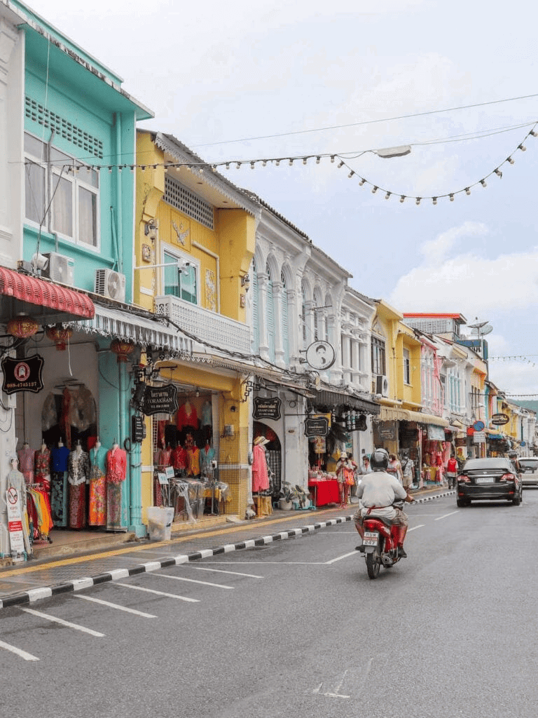 Colorful street with shops and outdoor markets in a vibrant city area.