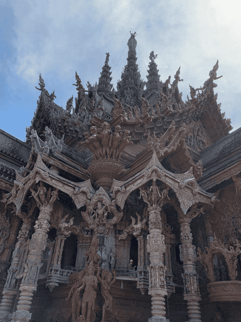 Intricate wooden temple architecture in Thailand with detailed carvings and spiritual motifs.