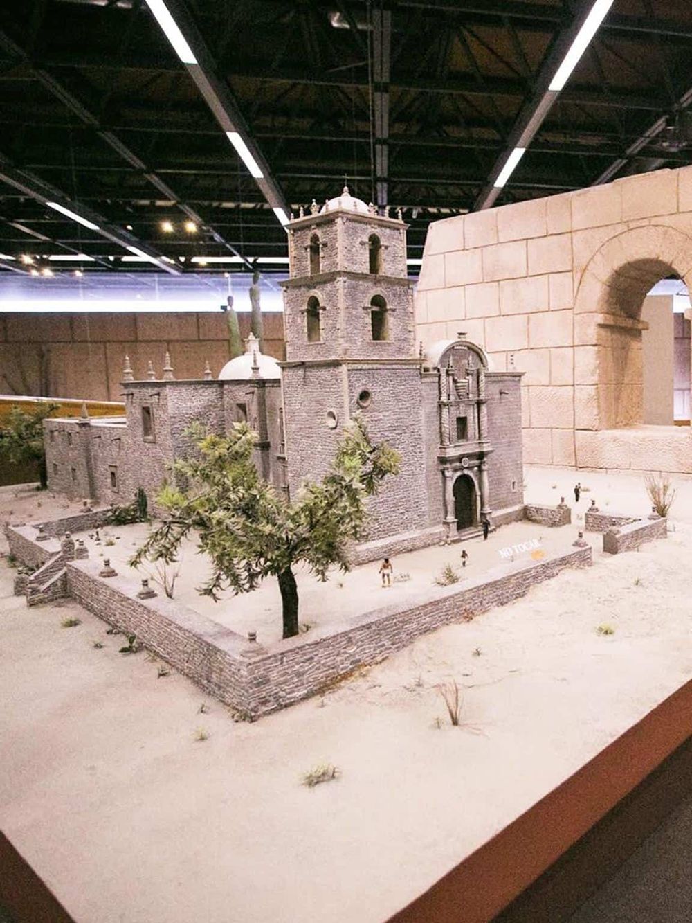 Miniature historical church model at QuestForDirections exhibit, showcasing landmarks and travel inspiration.