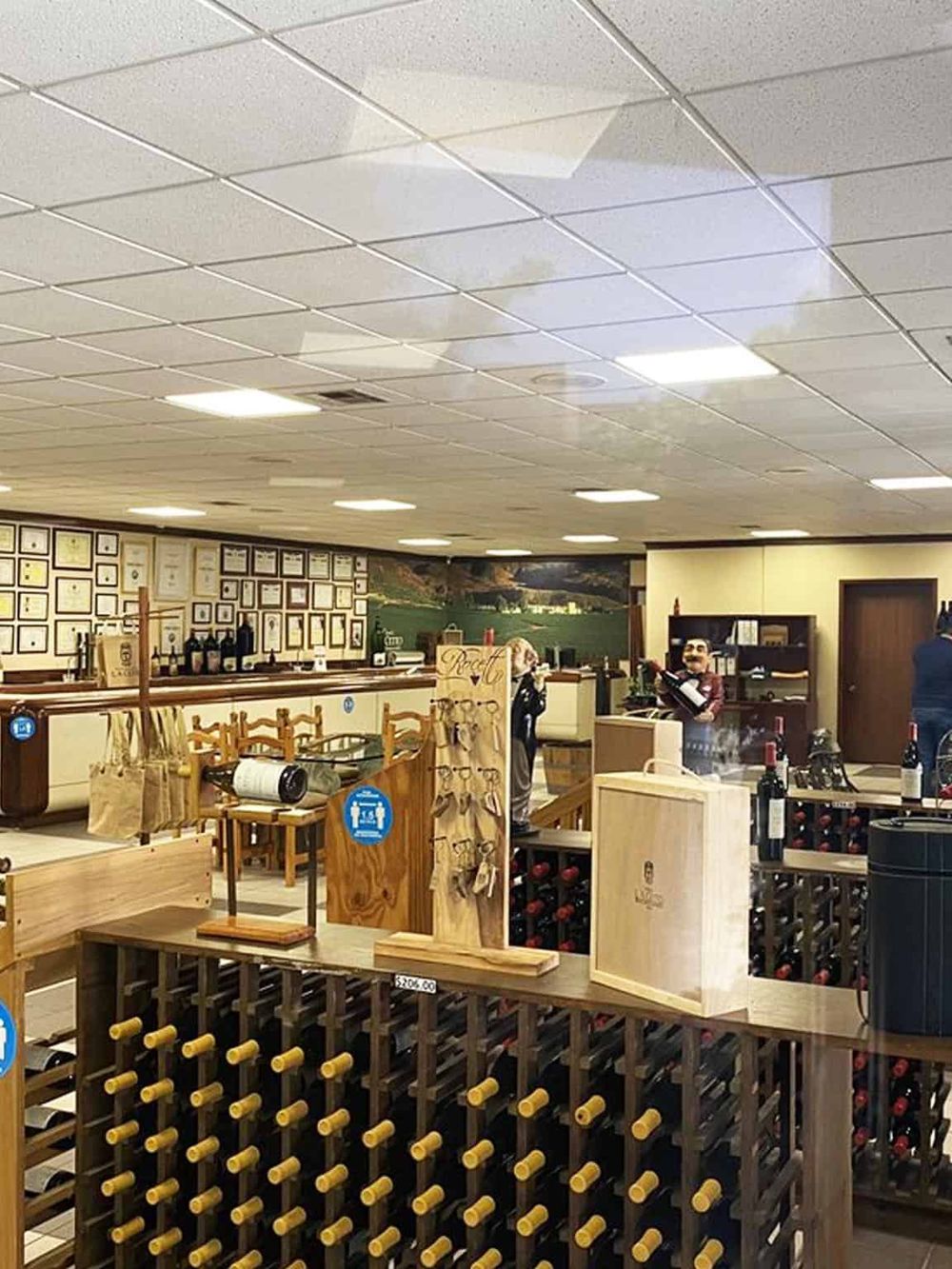 Welcoming wine shop interior at QuestForDirections, featuring wine displays, framed certificates, and tasting area.