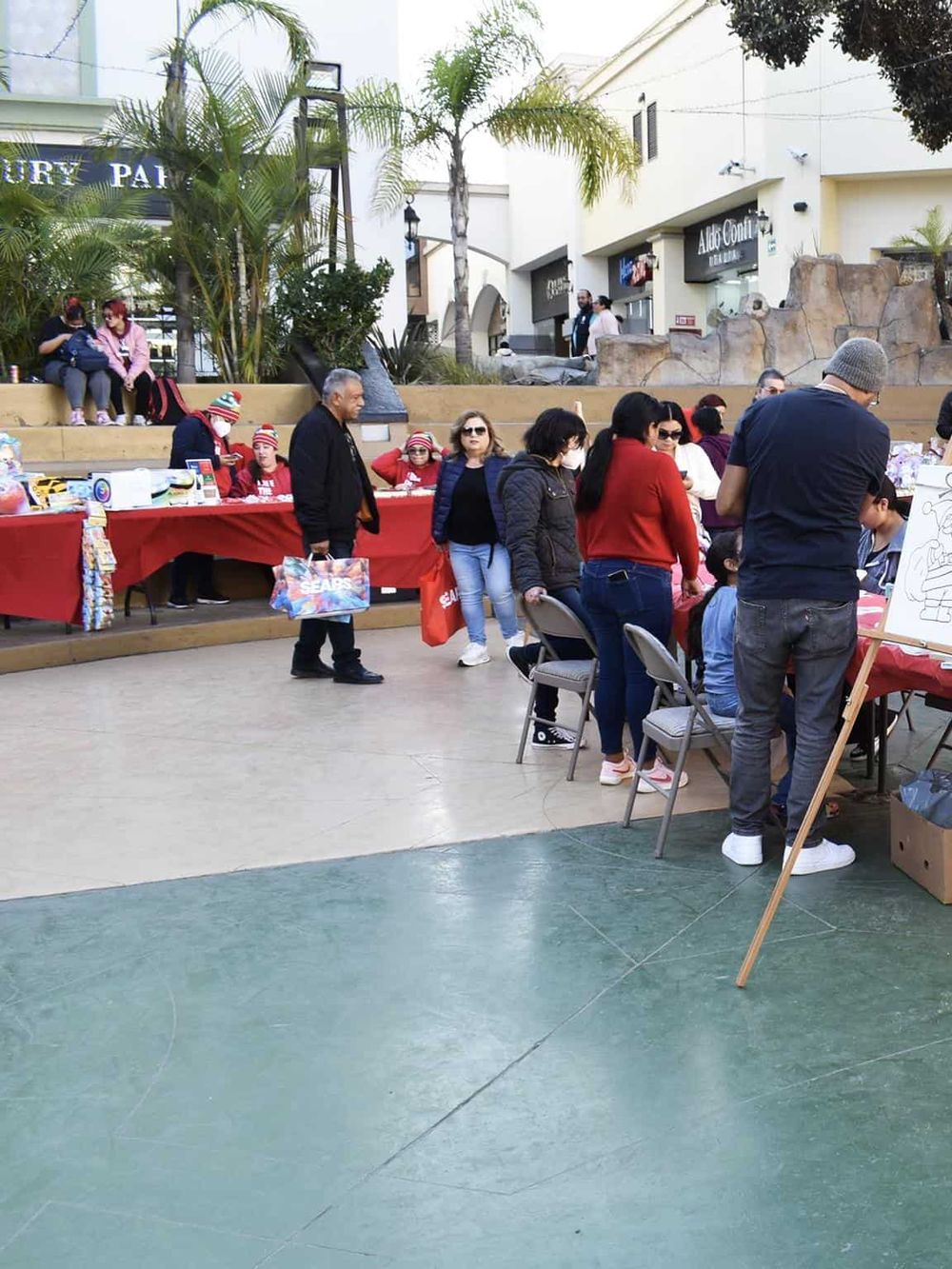 Outdoor holiday event promoting community and shopping in a shopping mall.