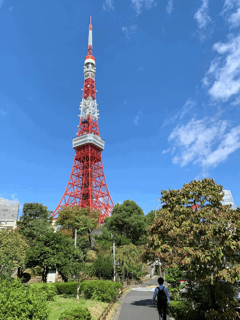 Tokyo Tower sightseeing landmark, bustling city view, iconic red and white structure, Japan travel destination.