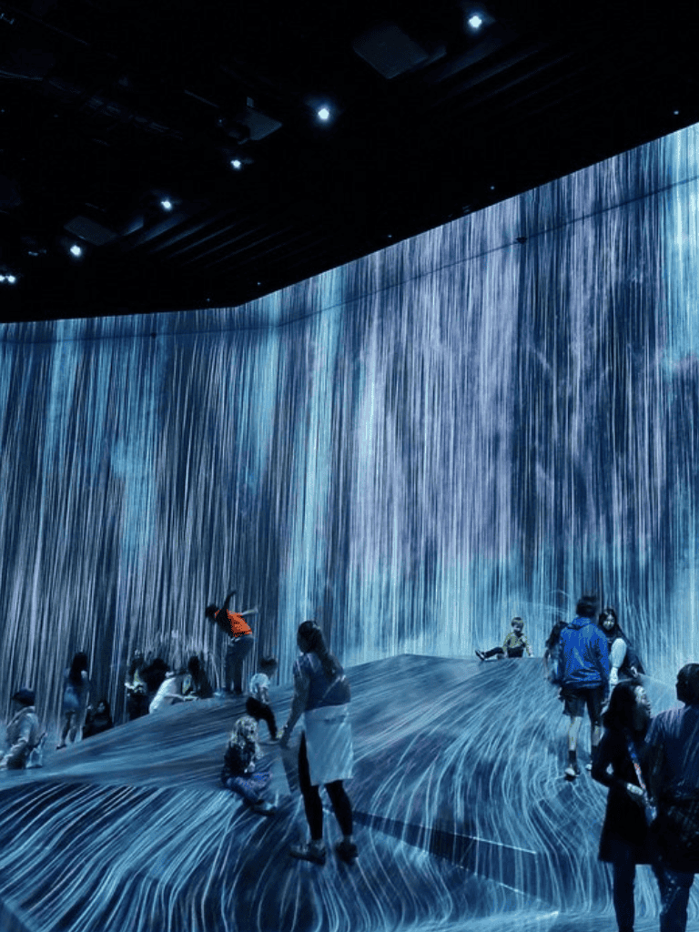 Immersive digital waterfall exhibit at QuestForDirections, vibrant interactive water display for visitors.