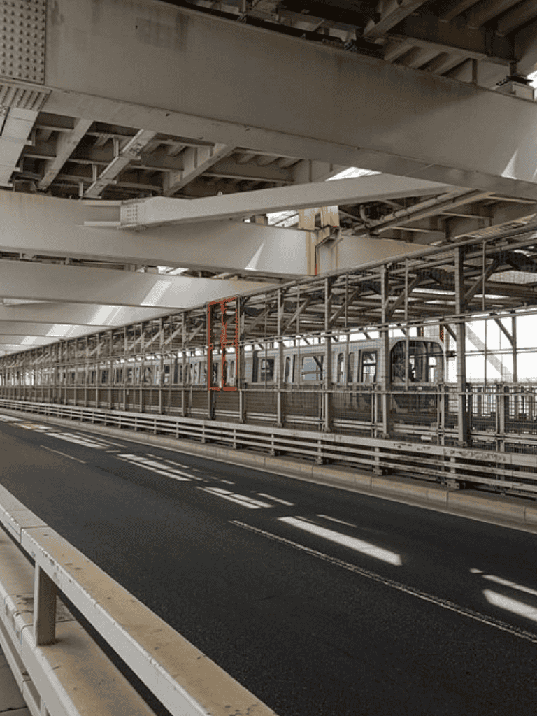 Overpass with train track and modern city architecture.