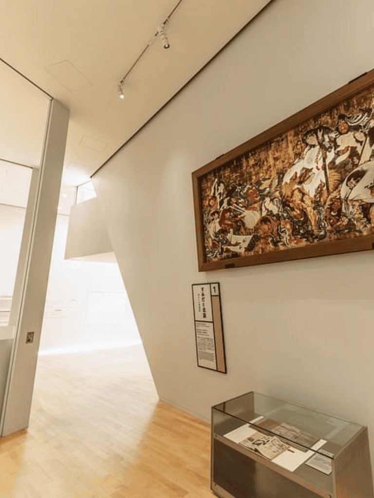 Vibrant tapestry artwork displayed in modern art gallery interior.