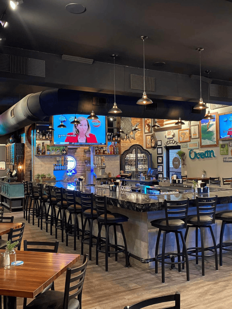 Relaxed ocean-themed restaurant with bar and TV screens for sports and news.