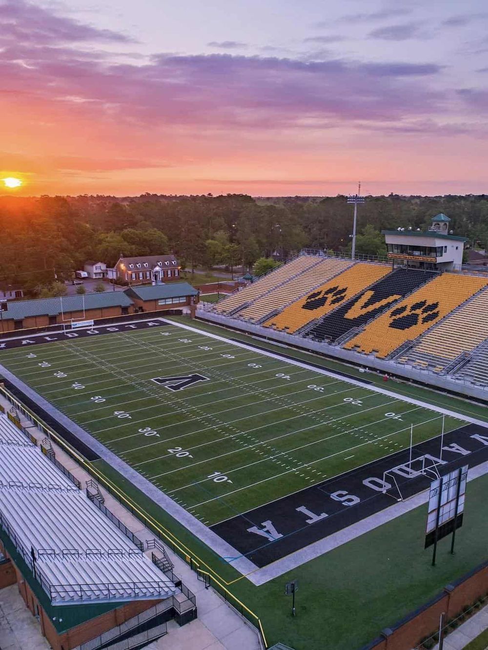 Brighton Field at dusk with sunset sky and stadium seating, home to Iowa State football games.