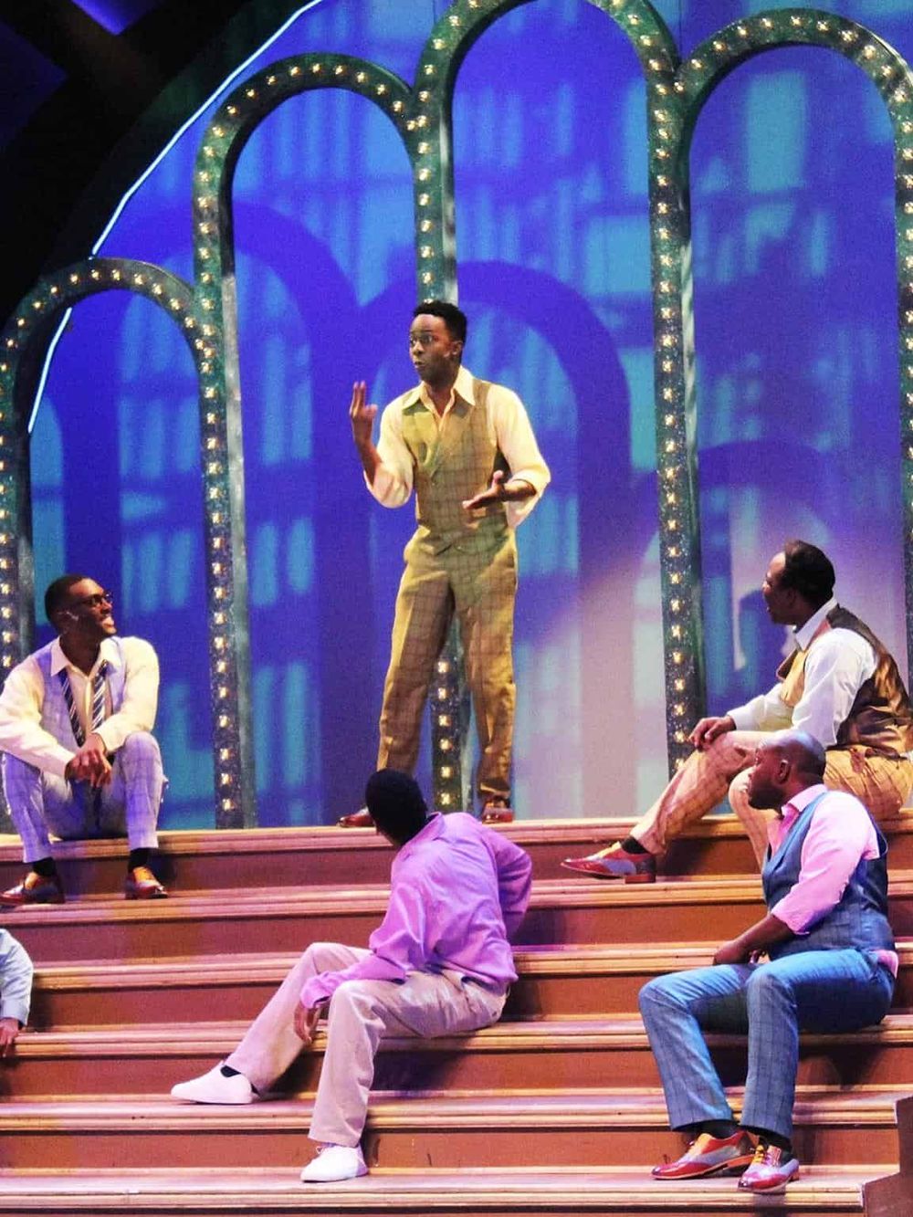 Vibrant theater scene with diverse actors performing on stage, highlighting innovative entertainment experiences.