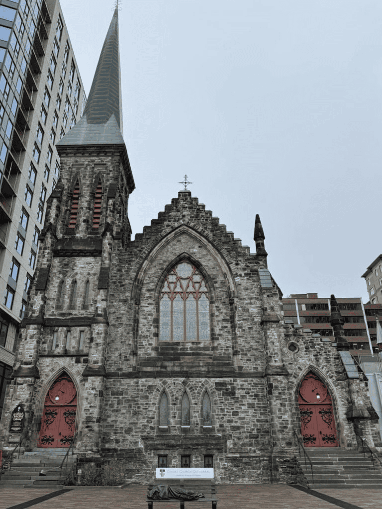 Ancient Gothic church with stone architecture and tall spire in city center.