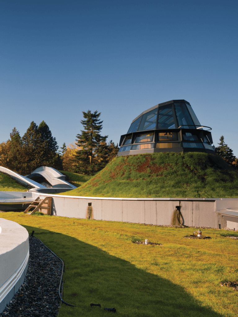 Modern U.S. Space Observation Tower with scenic surrounding nature and clear blue sky.