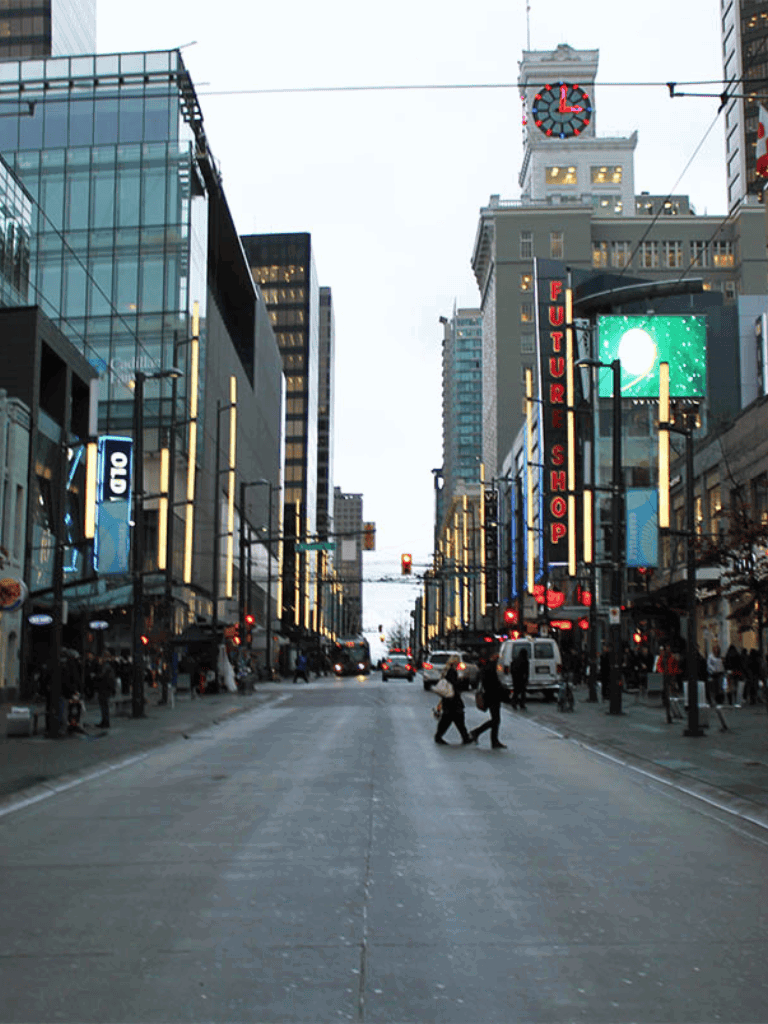 Bright city street with modern buildings and bustling crowd, ideal for exploring urban adventures.
