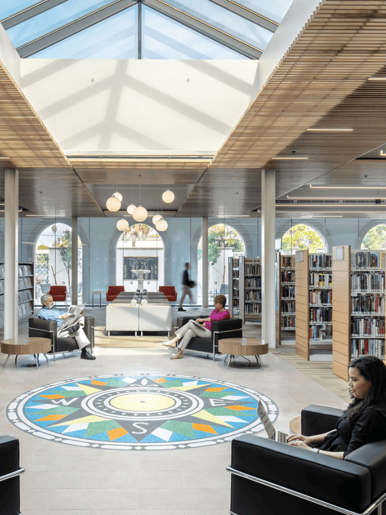 Aesthetic modern library interior with seating and bookshelves at QuestForDirections.