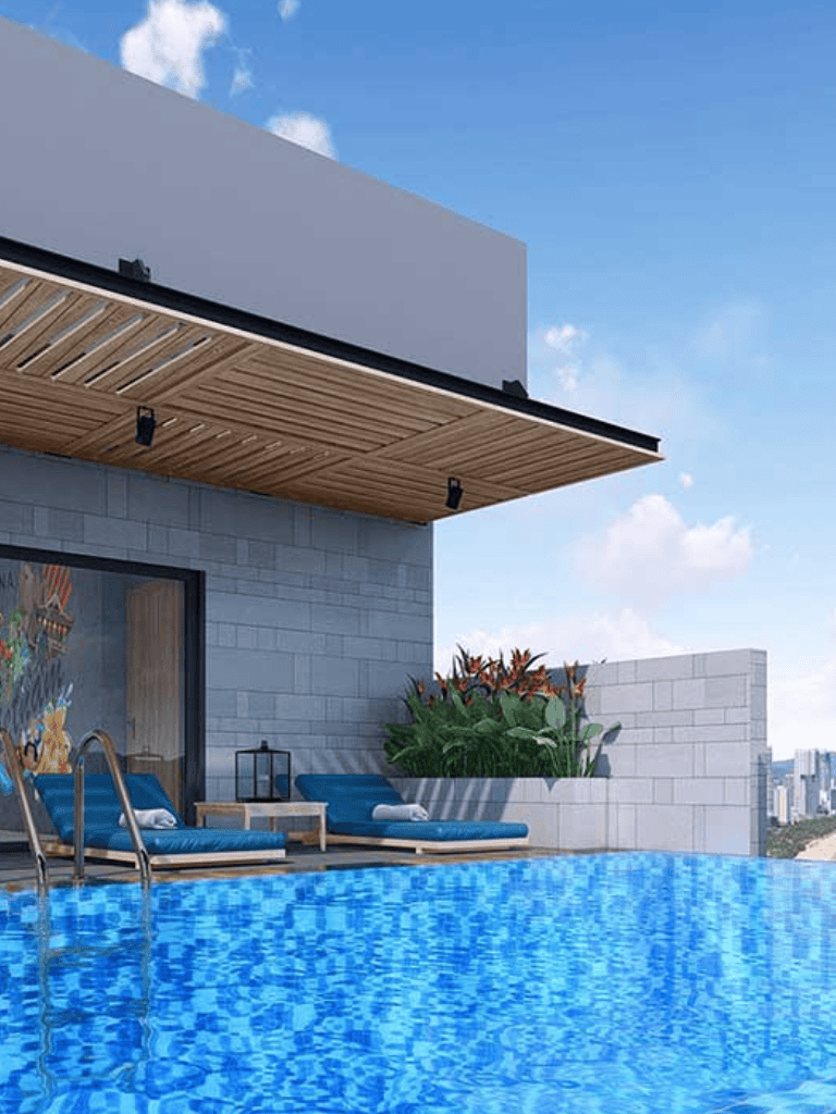 Luxurious rooftop infinity pool overlooking city skyline with modern outdoor lounge area.