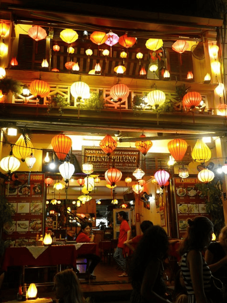 Colorful lanterns illuminate Vietnamese restaurant interior at night for authentic ambiance.
