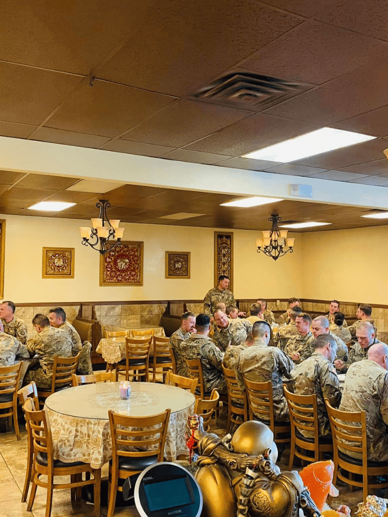 Military personnel dining in a restaurant with traditional decor.