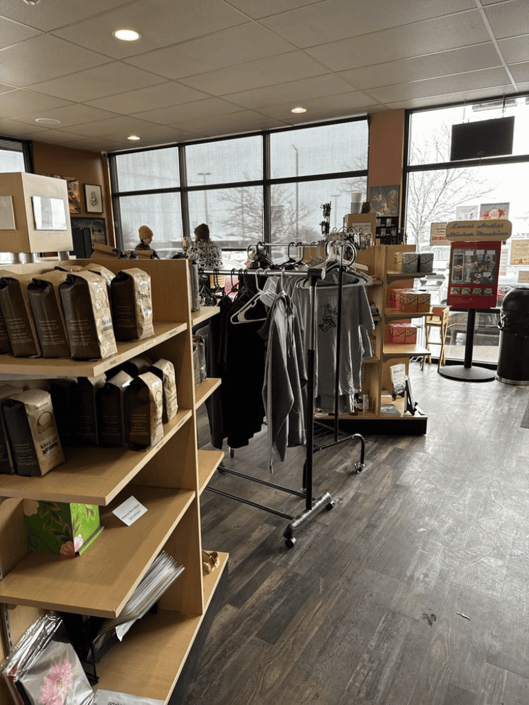Coffee beans and apparel display inside Quest for Directions store.