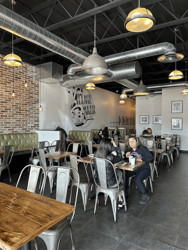 Cozy cafe interior with industrial design, exposed ductwork, and vintage decor promoting QuestForDirections.