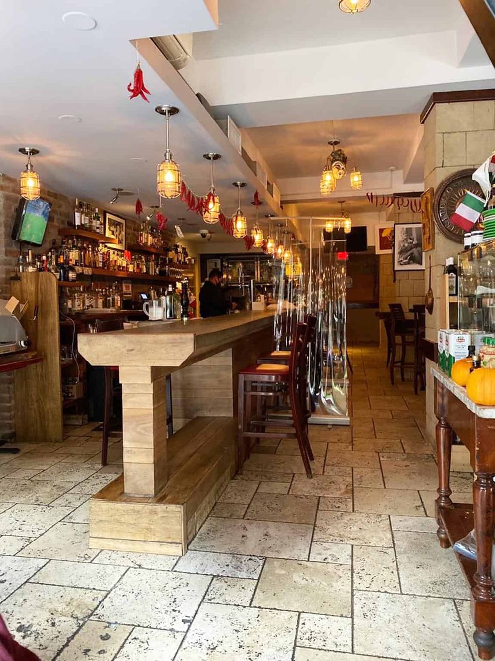 Cozy restaurant bar interior with warm lighting, wooden accents, and a festive atmosphere, perfect for dining and drinks.