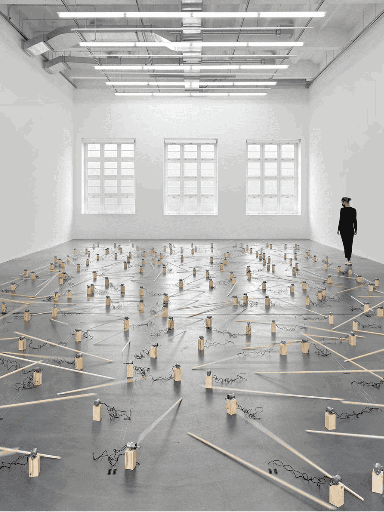 - Modern art installation with wooden blocks and wiring in a bright art gallery.