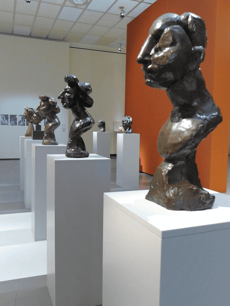 Modern bronze bust sculptures displayed at an art museum.
