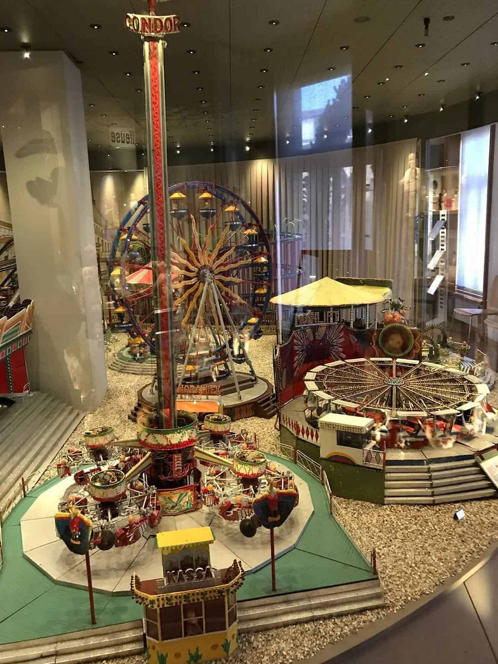 Colorful amusement park rides miniature display in a museum or exhibition.