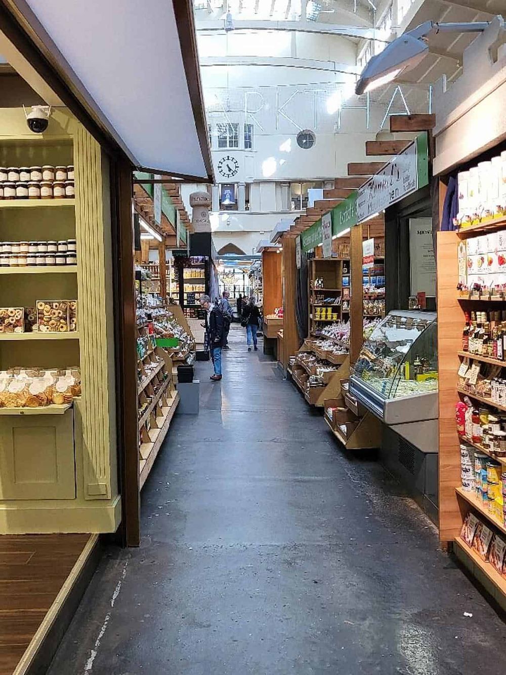 Vibrant indoor market aisle at QuestForDirections with fresh local produce and artisanal products.