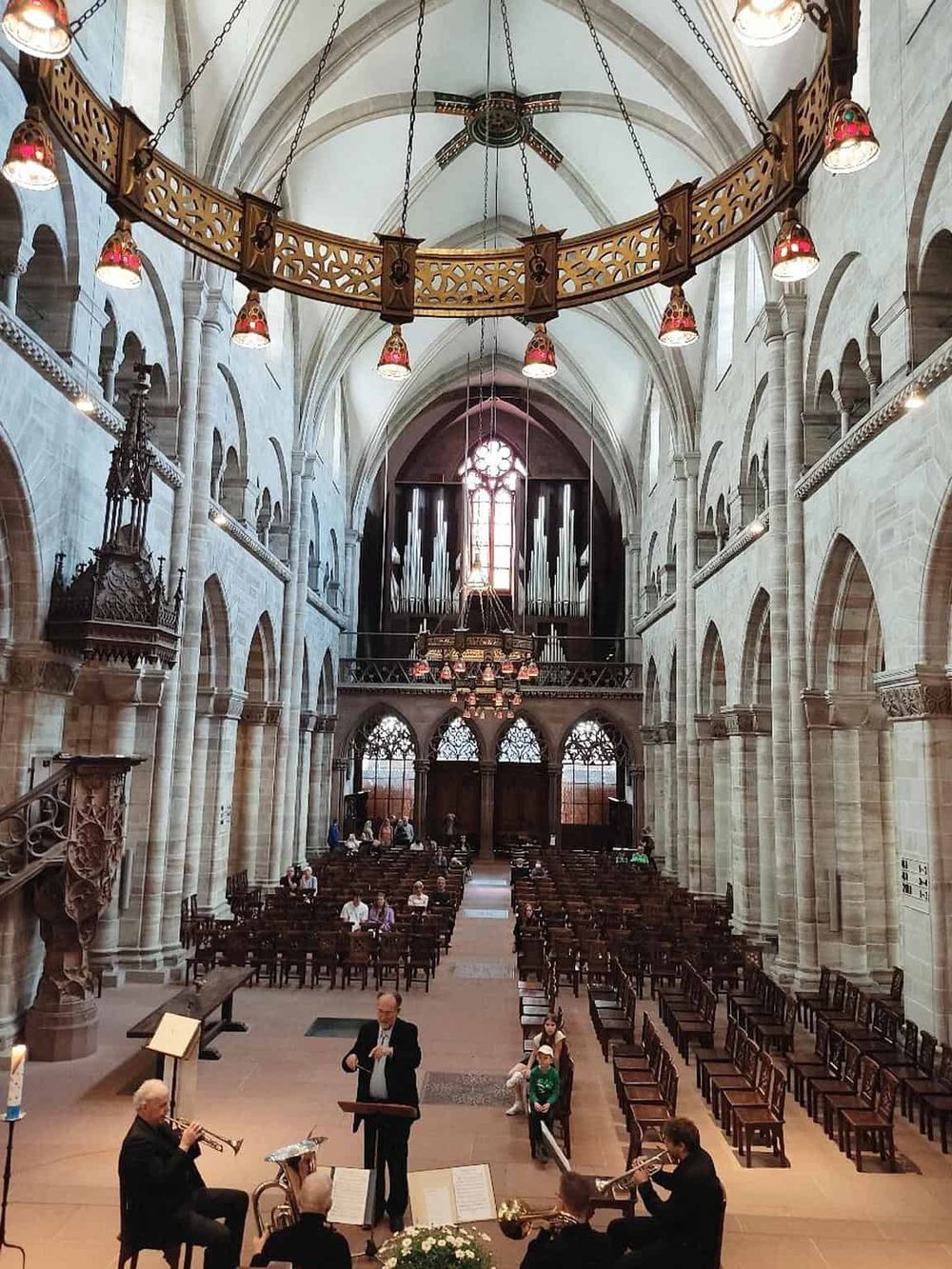 Intricate church interior with high vaulted ceilings, organ, and live jazz performance for spiritual and cultural enrichment.