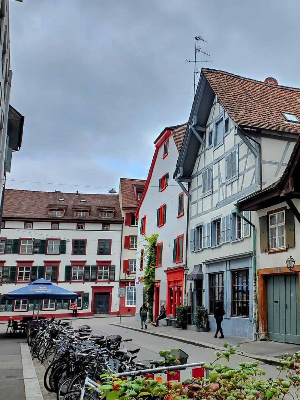 Colorful European street with historic buildings and parked bicycles, highlighting travel destinations and city exploration.