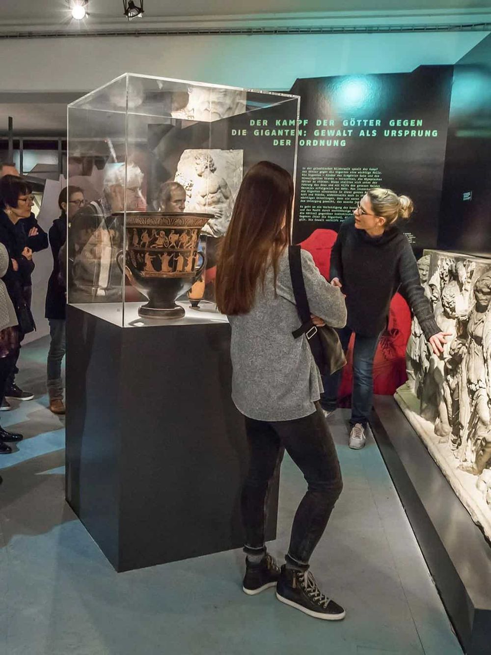 Ancient artifacts exhibit at Quest for Directions museum, showcasing Greek pottery and sculptures.