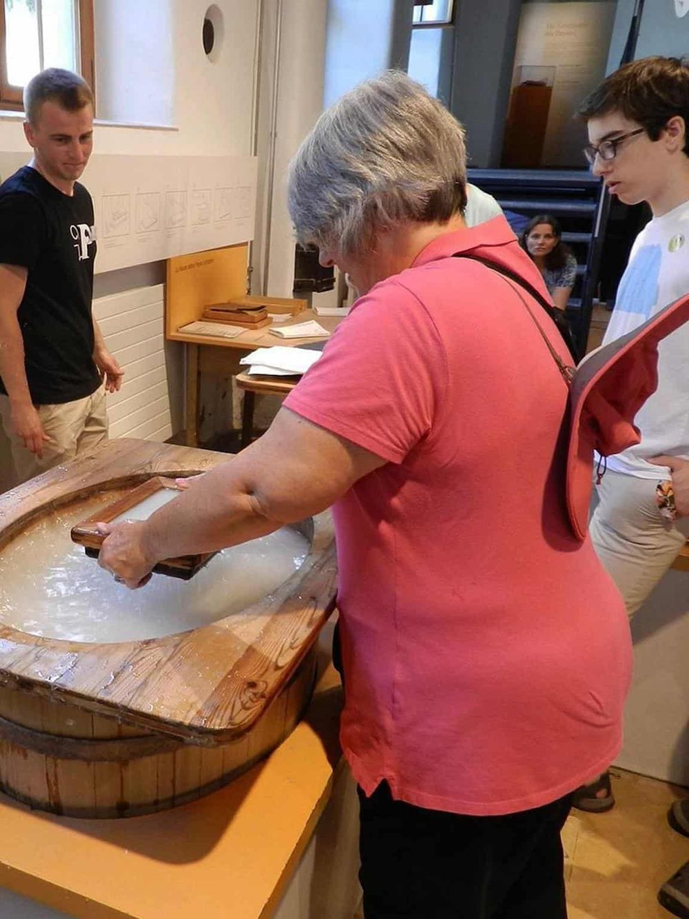 Traditional sake brewing process demonstration at QuestForDirections exhibit.