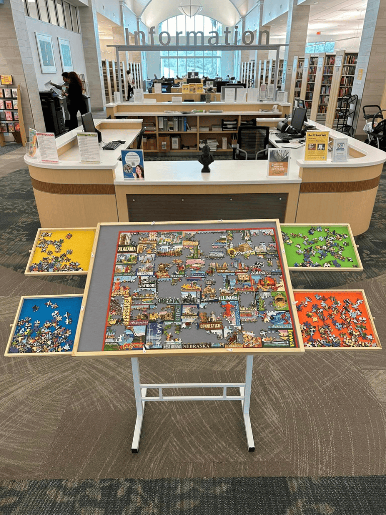 Puzzle of the United States map at library information desk for travel planning and geography education.