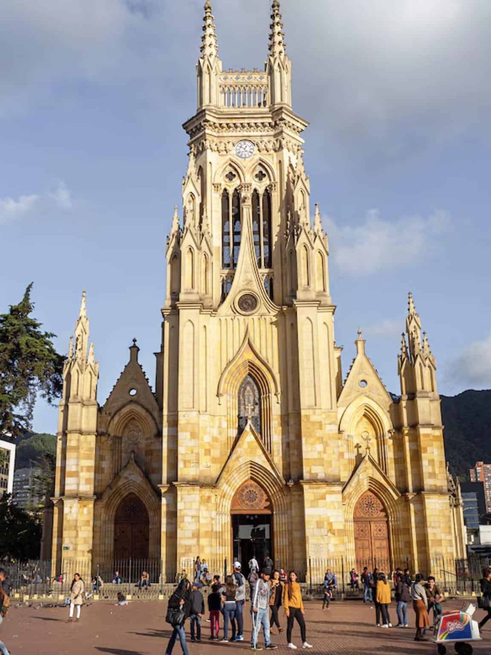 Intricately designed Gothic church with a bustling crowd in front, showcasing historic architecture and popular tourist destination.